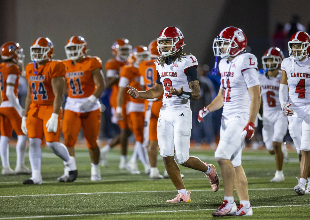 Orange Lutheran quarterback Tj Lateef (9) is dismayed by a lack of a penalty on Bishop Gorman d ...