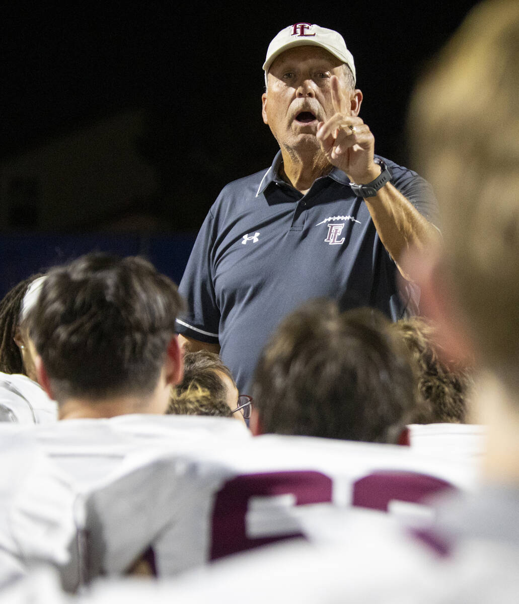 Faith Lutheran Head Coach Michael Sanford speaks to the team after the 35-20 win over Shadow Ri ...