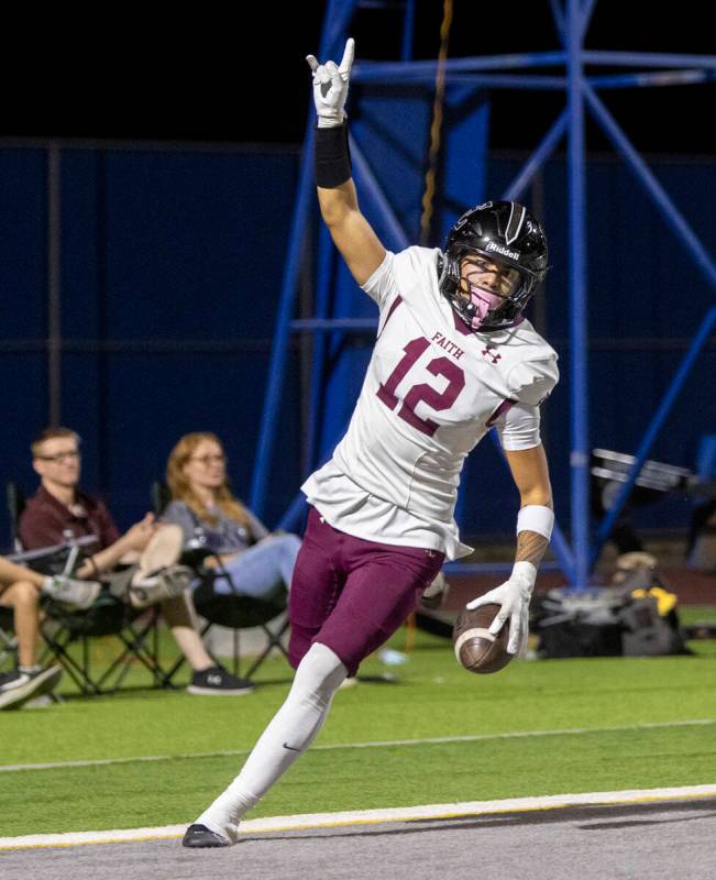 Faith Lutheran junior Aipa Kuloloia (12) celebrates after scoring a touchdown during the high s ...