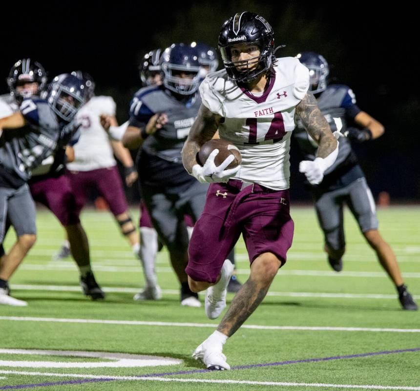 Faith Lutheran senior Cale Breslin (14) runs the ball during the high school football game agai ...