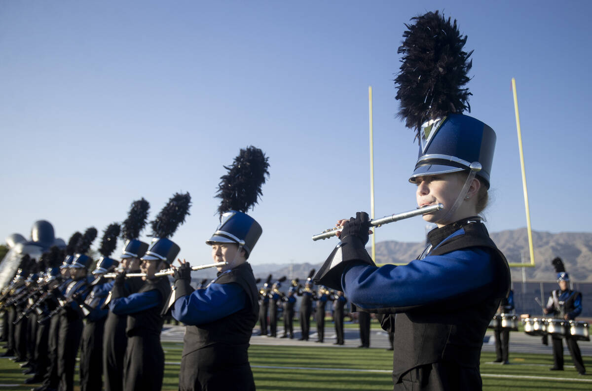 Shadow Ridge Thundering Herd marching band members play the fight song before the high school f ...