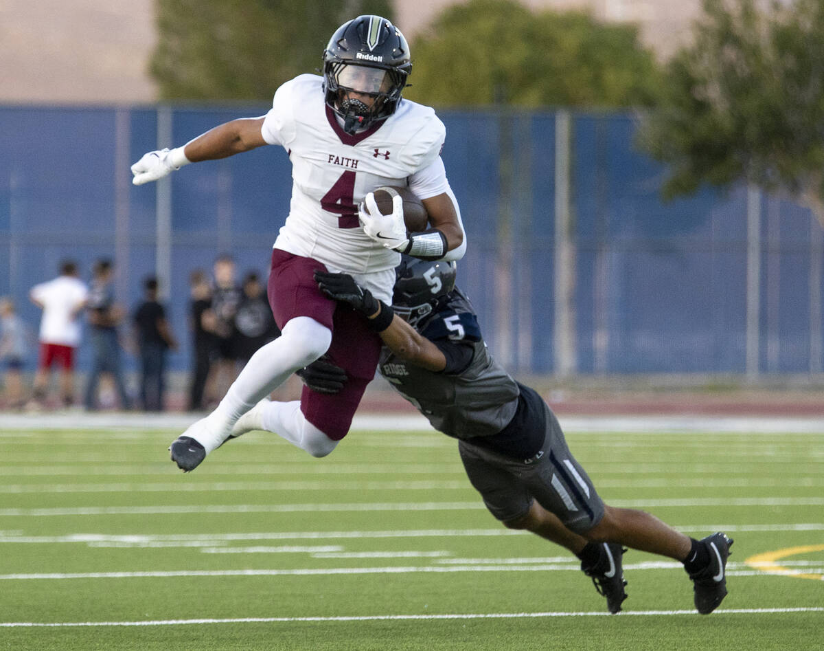 Faith Lutheran junior Rouselle Shepard (4) attempts to hurdle Shadow Ridge sophomore Isaiah Rui ...