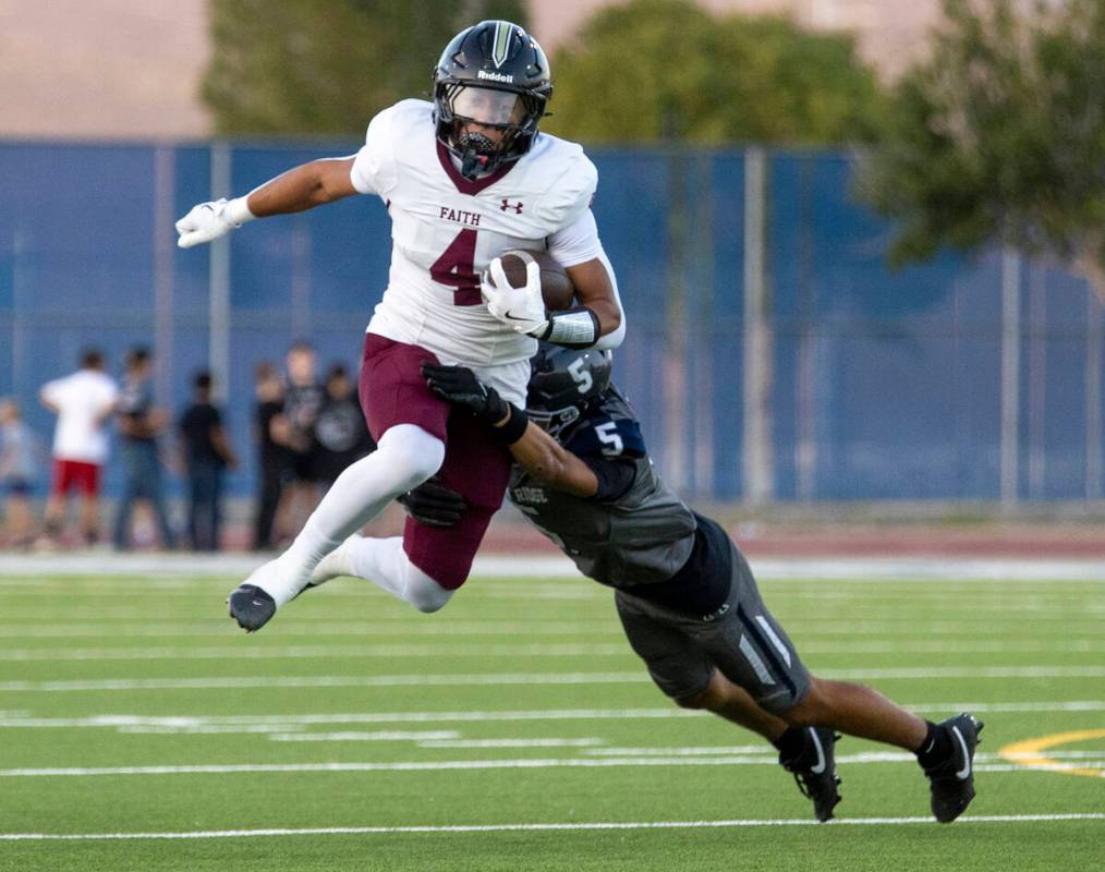 Faith Lutheran junior Rouselle Shepard (4) attempts to hurdle Shadow Ridge sophomore Isaiah Rui ...