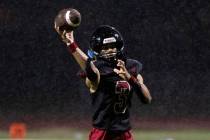 Las Vegas quarterback Tanner Vibabul (3) throws for a touchdown during the first half of a high ...