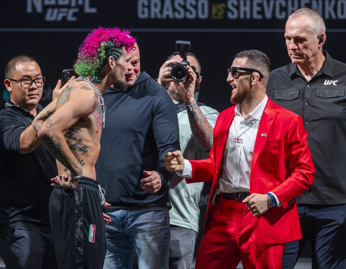 Fighters Sean O'Malley, left, and Merab Dvalishvili talk to each other in their face off for th ...