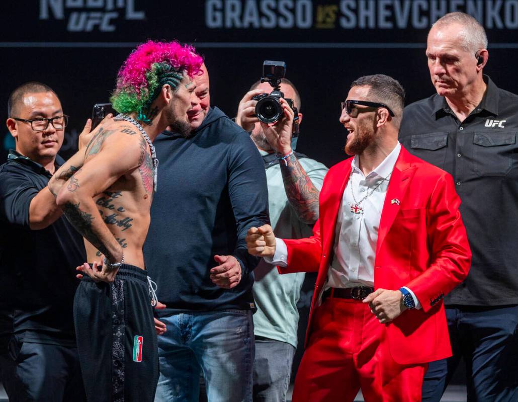 Fighters Sean O'Malley, left, and Merab Dvalishvili talk to each other in their face off for th ...