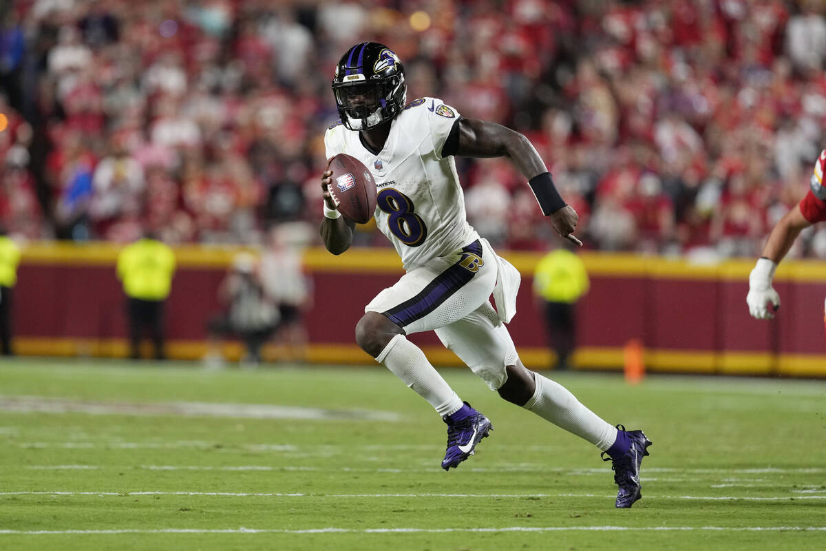 Baltimore Ravens quarterback Lamar Jackson runs against the Kansas City Chiefs during an NFL fo ...