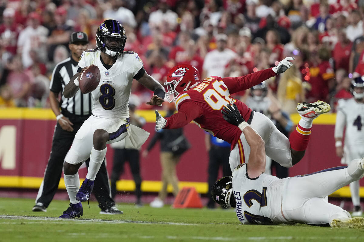 Baltimore Ravens quarterback Lamar Jackson (8) scrambles as Kansas City Chiefs defensive tackle ...