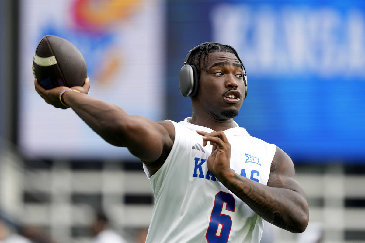 Kansas quarterback Jalon Daniels warms up prior to an NCAA college football game against UNLV, ...