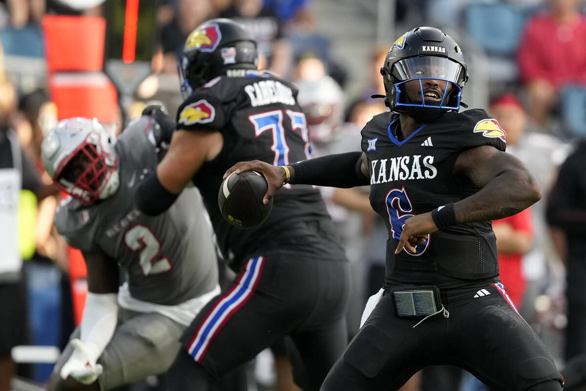 Kansas Jayhawks quarterback Jalon Daniels passes against the UNLV Rebels in the first half of a ...