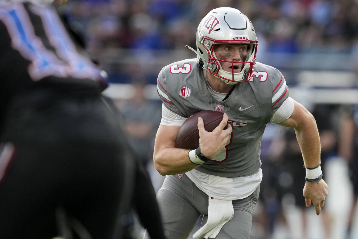 UNLV quarterback Matthew Sluka runs with the ball in the first half against Kansas during an NC ...