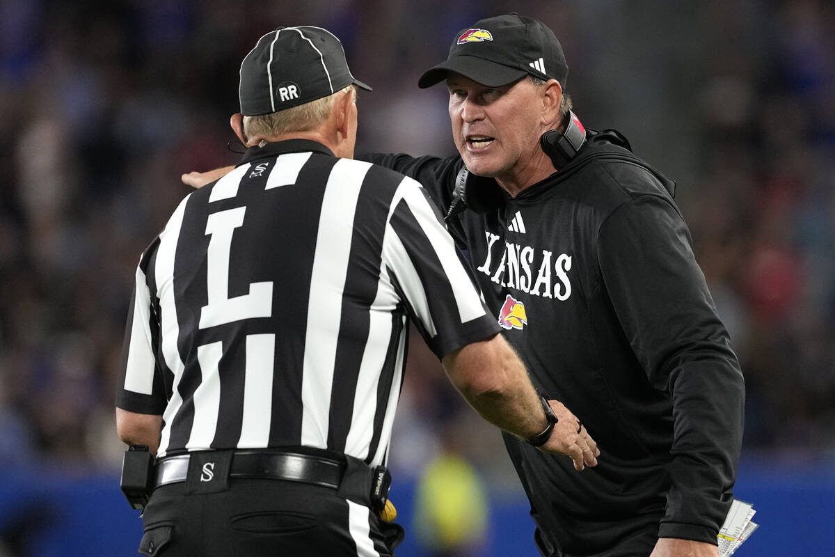 Kansas head coach Lance Leipold, right, talks to an official, left, after a penalty in the seco ...