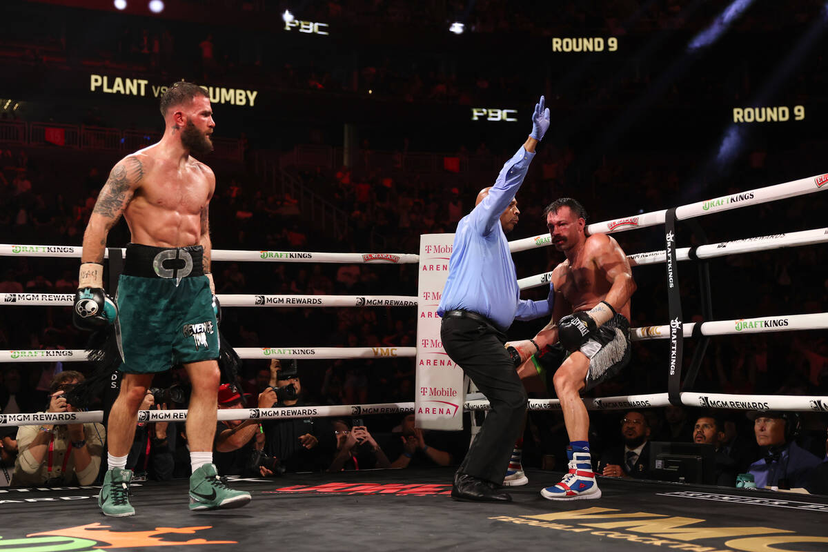 Trevor McCumby, right, stumbles to the mat while Caleb Plant reacts during a super middleweight ...