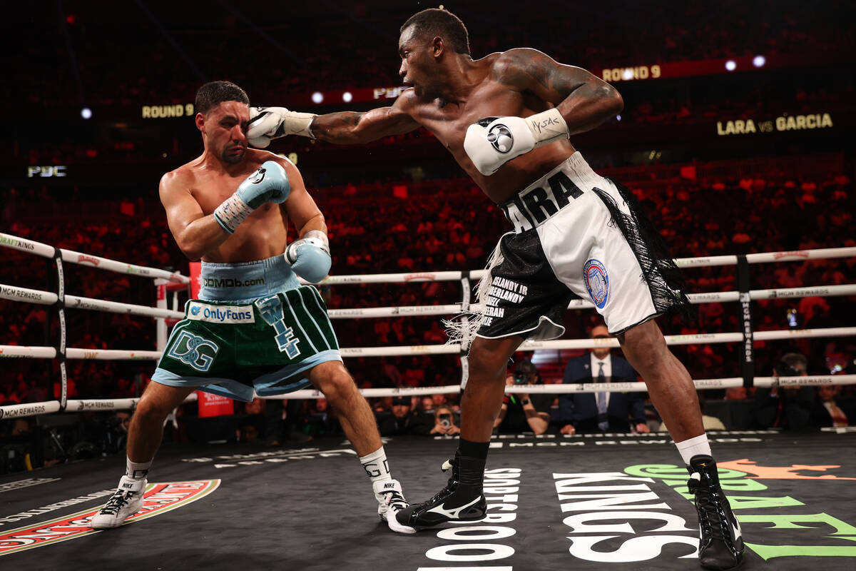 Erislandy Lara gets a right on Danny Garcia during a middleweight championship boxing bout at T ...