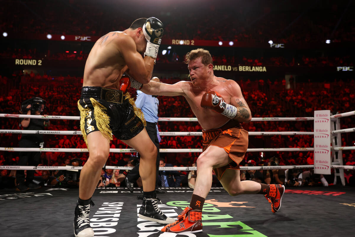 Canelo Alvarez gets a body shot on Edgar Berlanga during a super middleweight championship boxi ...