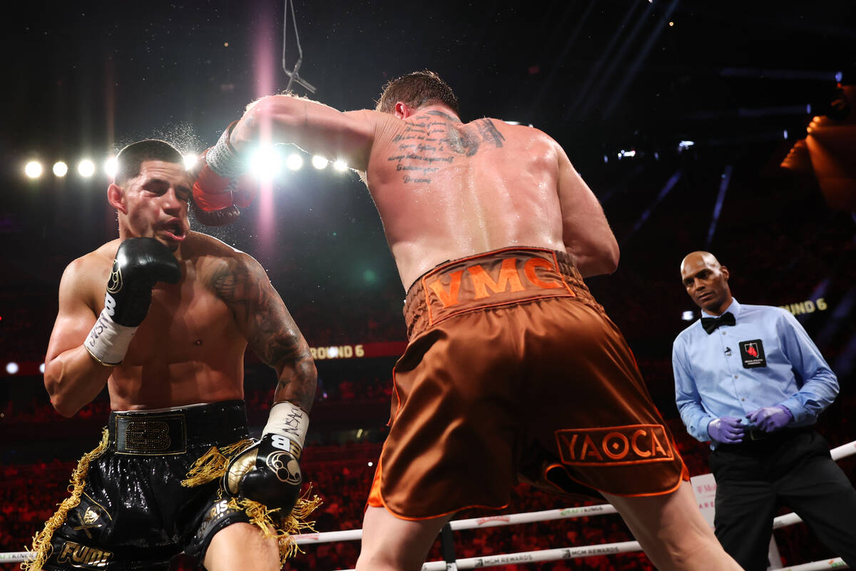 Canelo Alvarez gets a left on Edgar Berlanga during a super middleweight championship boxing bo ...