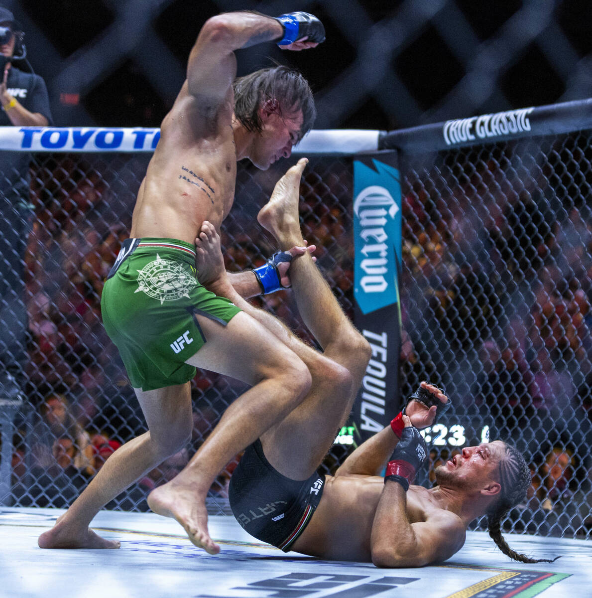 Featherweight Diego Lopes attacks Brian Ortega from above in their fight during UFC 306: Riyad ...