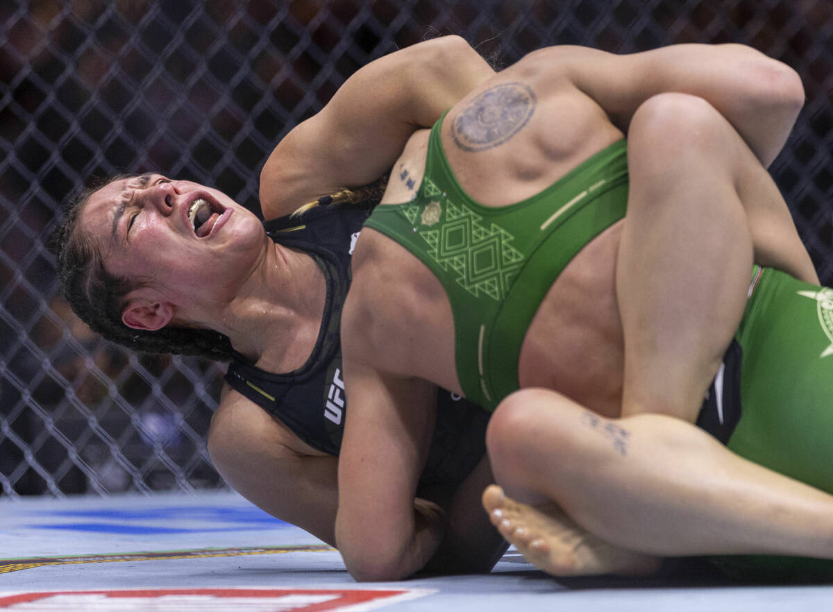 Women's flyweight title fighter Alexa Grasso yells out as she holds the head of Valentina Shevc ...