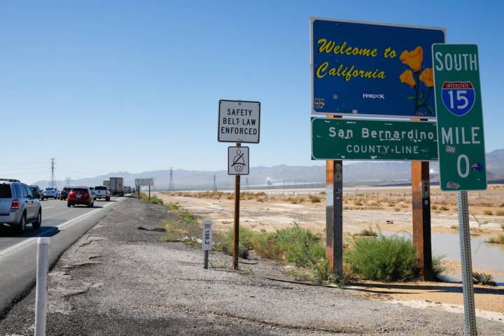 FILE - Cars traveling back to California in traffic on I-15 as they pass over the state border ...