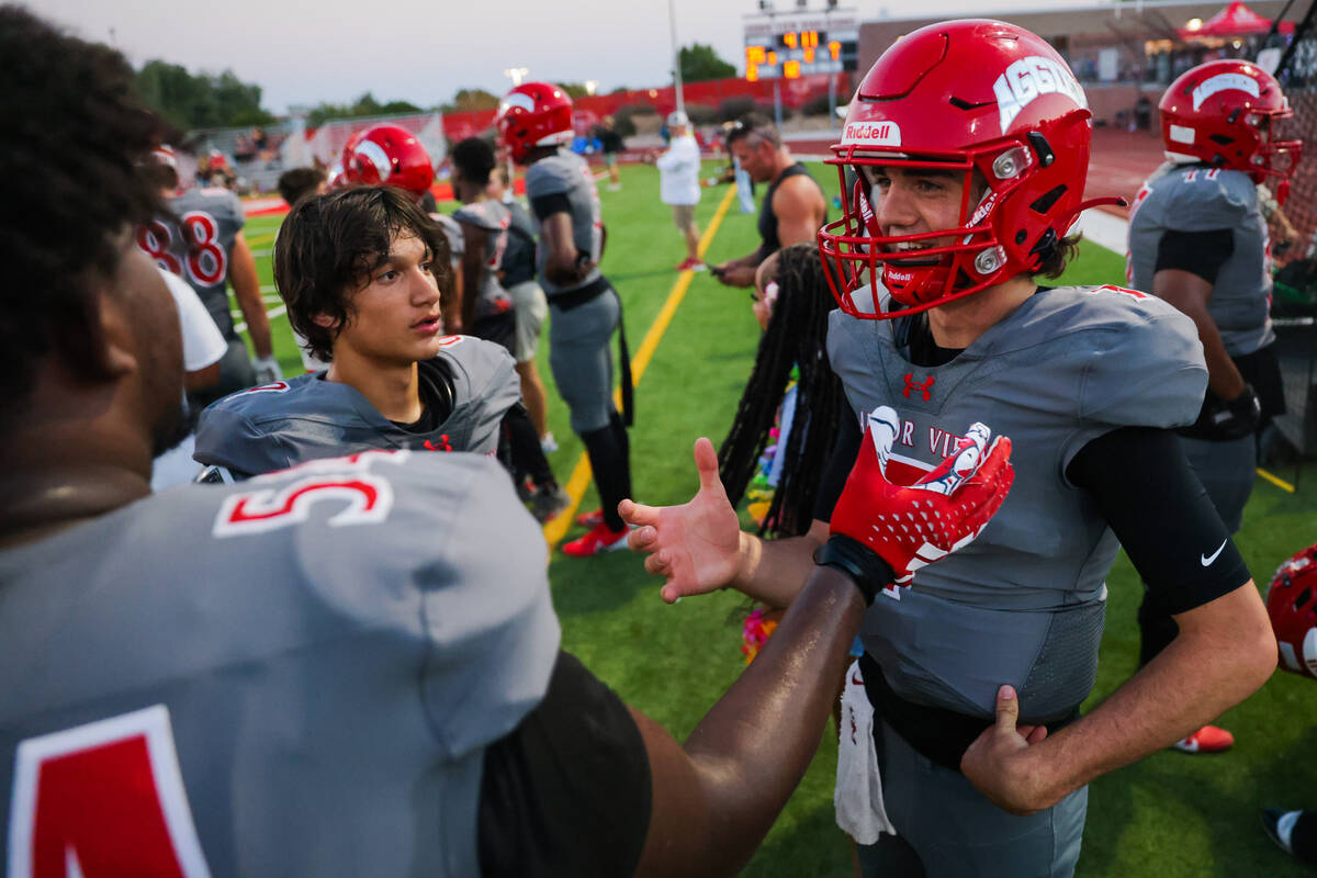 Arbor View quarterback Thaddeus Thatcher speaks to a teammate on the sidelines during a game ag ...