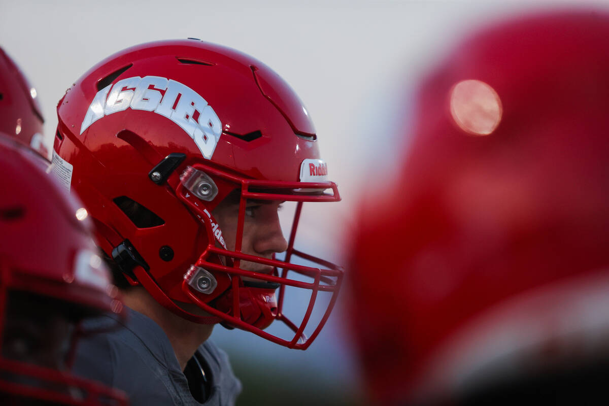 Arbor View quarterback Thaddeus Thatcher stands in a huddle during a time out at a game against ...