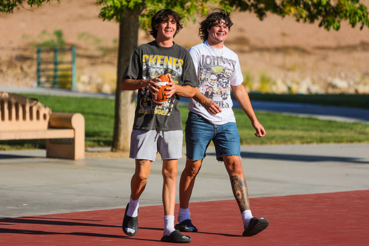 Thaddeus Thatcher, left, laughs as he walks alongside his brother, Christian, at Sunny Springs ...