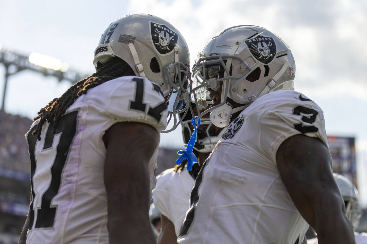 Raiders wide receiver Davante Adams (17) celebrates scoring a touchdown with running back Zamir ...