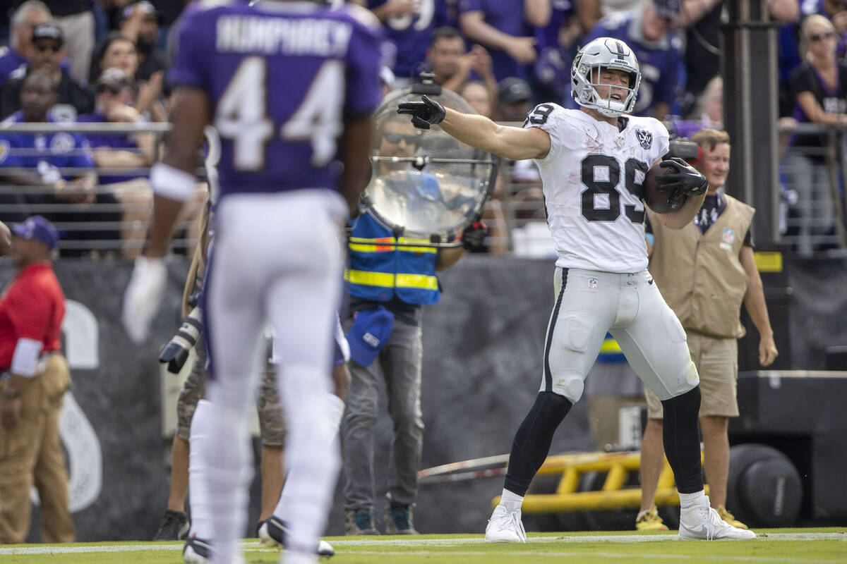 Raiders tight end Brock Bowers (89) motions for a first down after a catch during the second ha ...