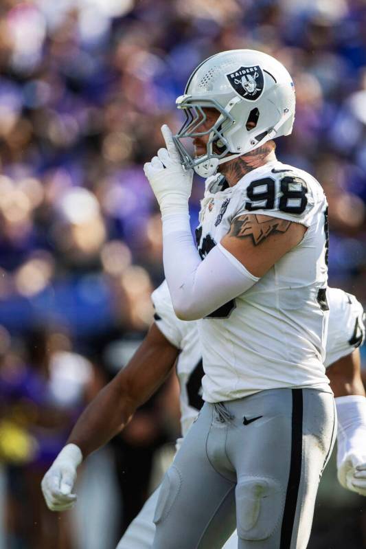 Raiders defensive end Maxx Crosby (98) motions for silence after sacking Baltimore Ravens quart ...