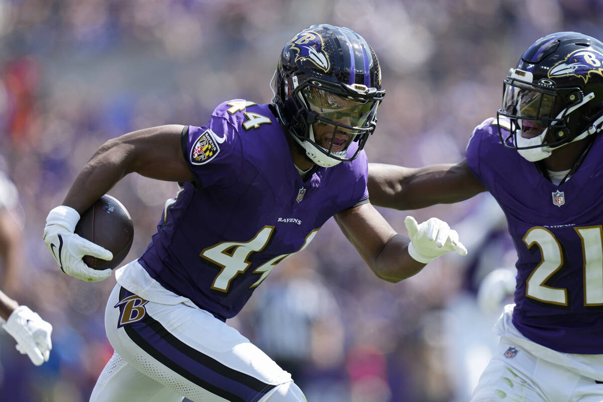 Baltimore Ravens cornerback Marlon Humphrey (44) runs with the ball after making an interceptio ...