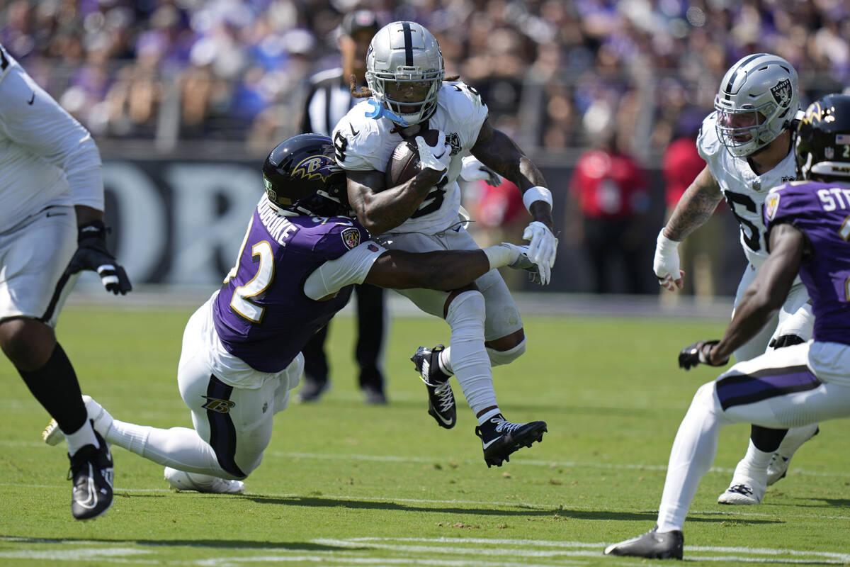 Baltimore Ravens defensive tackle Nnamdi Madubuike (92) tackles Las Vegas Raiders running back ...