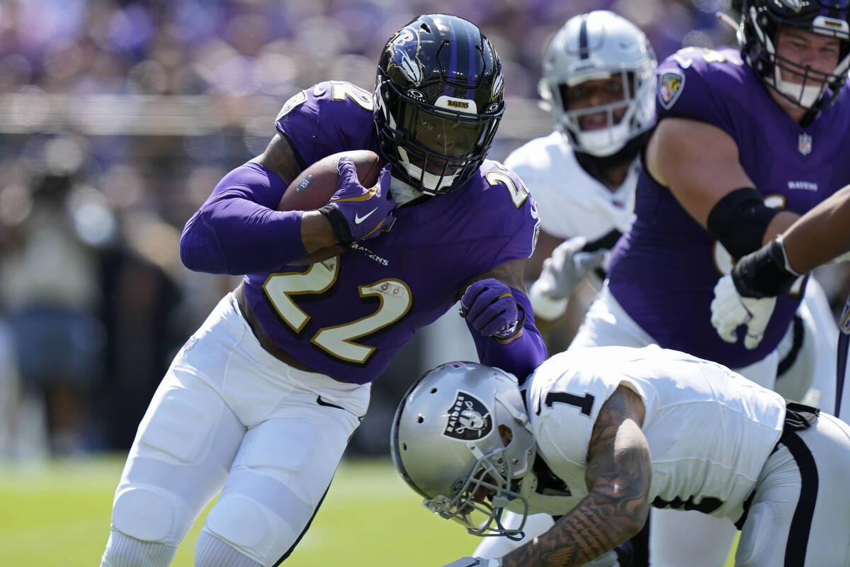 Baltimore Ravens running back Derrick Henry (22) is tackled by Las Vegas Raiders safety Marcus ...