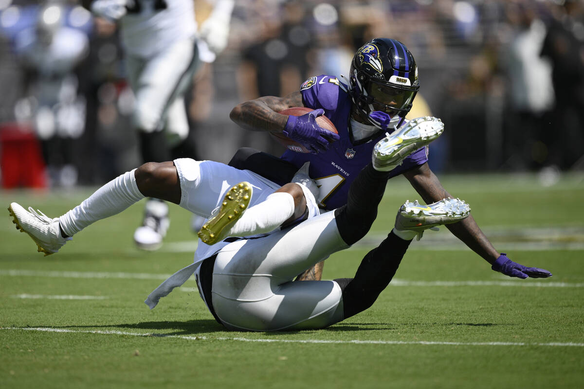 Las Vegas Raiders safety Marcus Epps (1) tackles Baltimore Ravens wide receiver Zay Flowers (4) ...