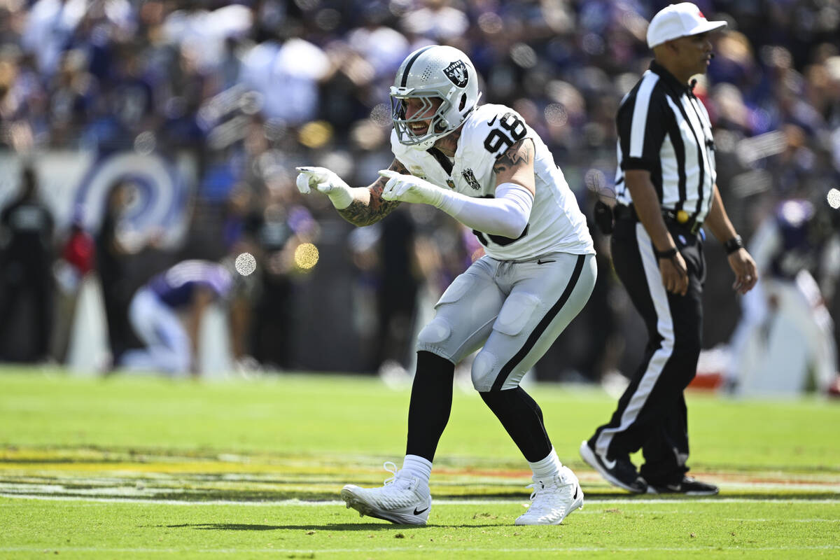 Las Vegas Raiders defensive end Maxx Crosby (98) gestures after sacking Baltimore Ravens quarte ...