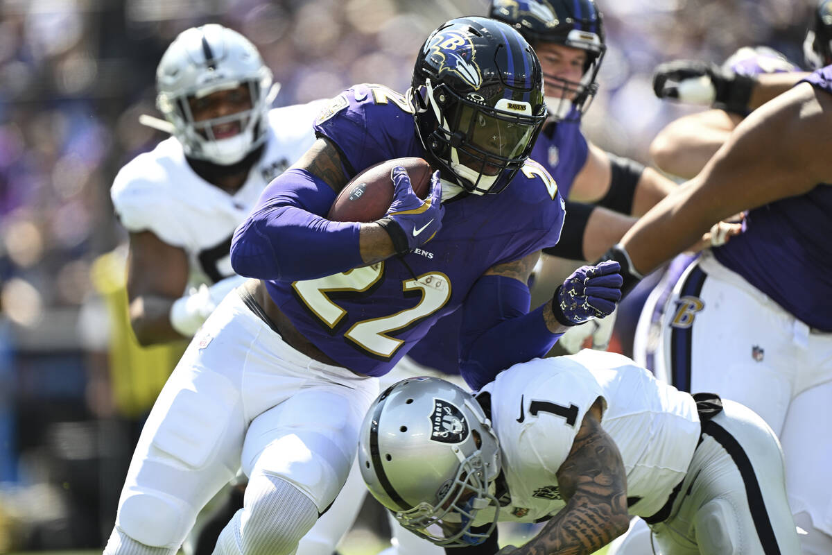 Baltimore Ravens running back Derrick Henry (22) runs the ball and is tackled by Las Vegas Raid ...