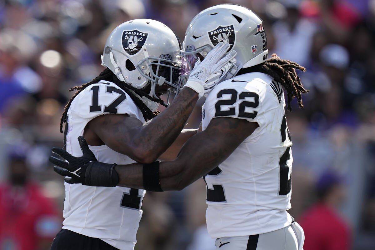 Las Vegas Raiders wide receiver Davante Adams (17) celebrates after running back Alexander Matt ...