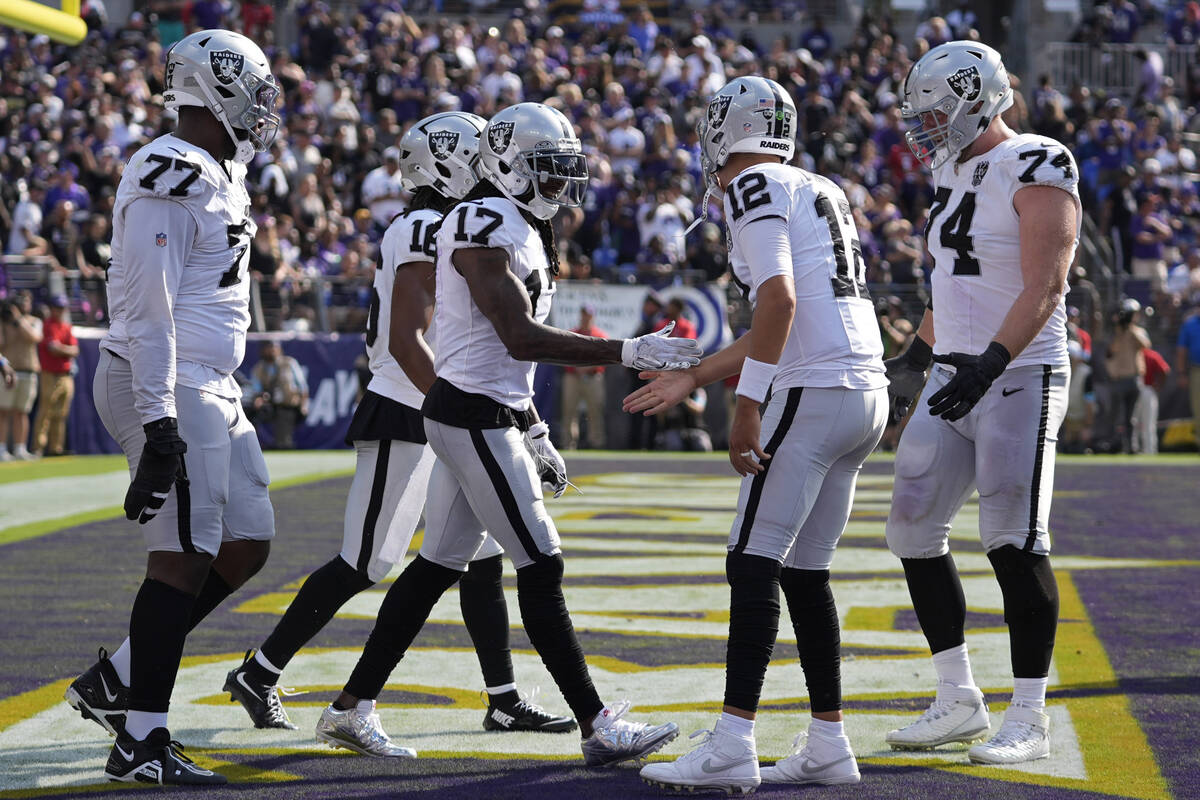 Las Vegas Raiders wide receiver Davante Adams (17) celebrates after scoring a touchdown against ...