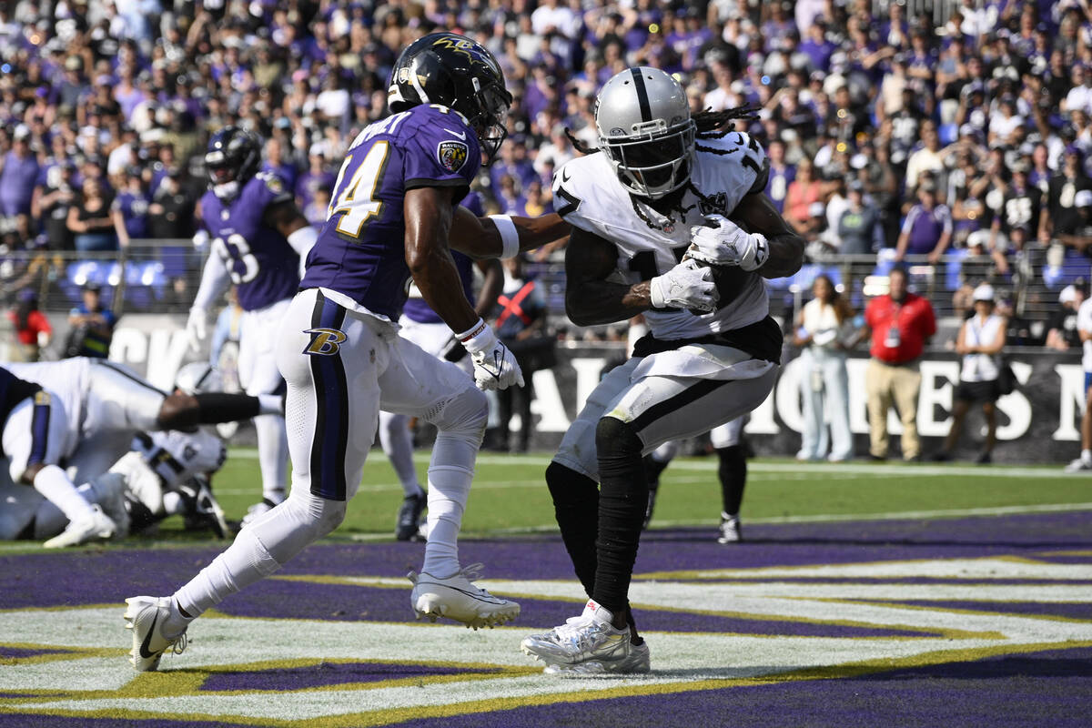 Las Vegas Raiders wide receiver Davante Adams (17) catches a touchdown pass against Baltimore R ...