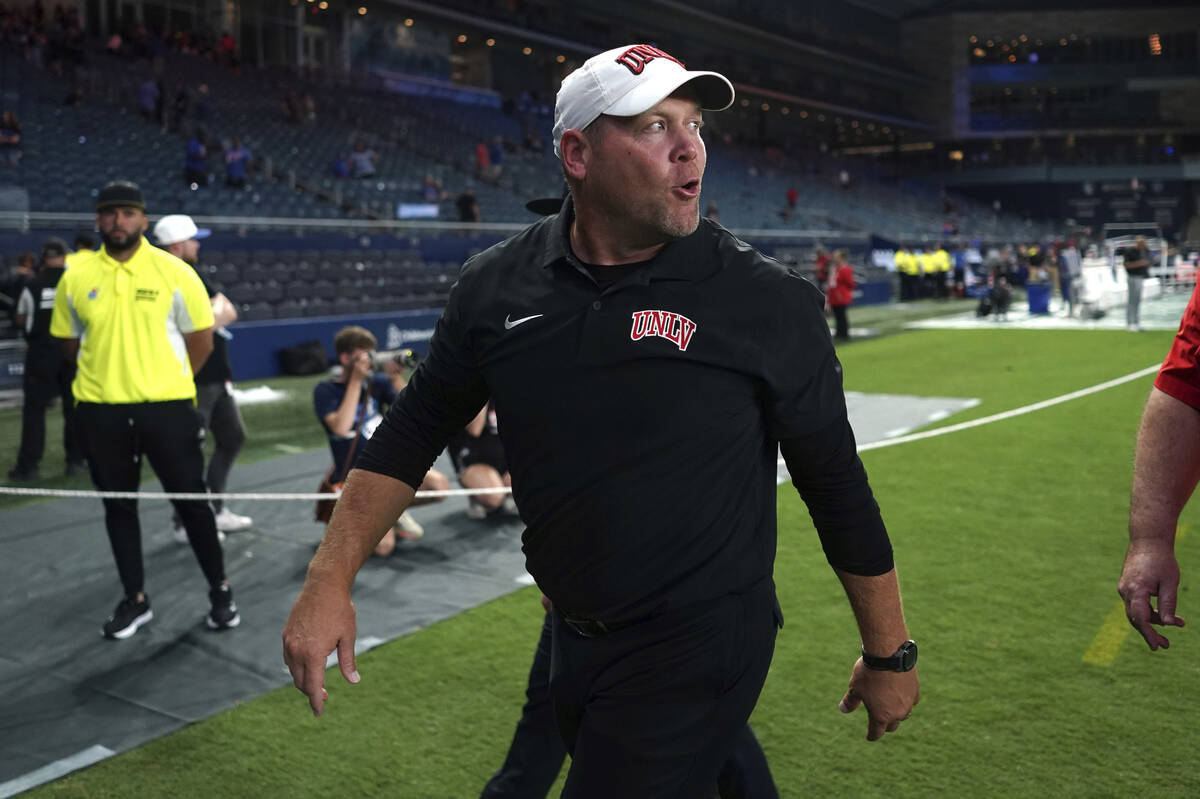 UNLV head coach Barry Odom walks off the field after win over Kansas in an NCAA college footbal ...