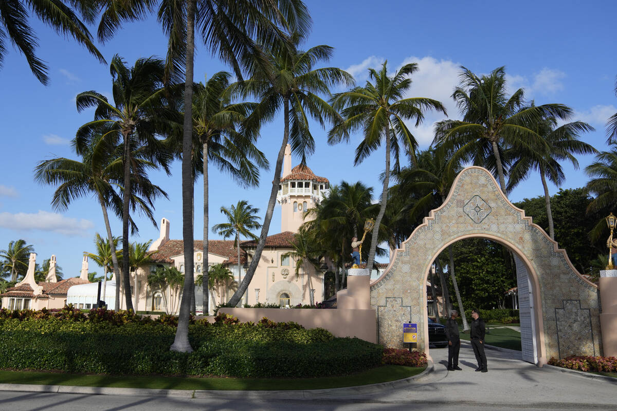 FILE - Security agents talk at the entrance to former President Donald Trump's Mar-a-Lago estat ...