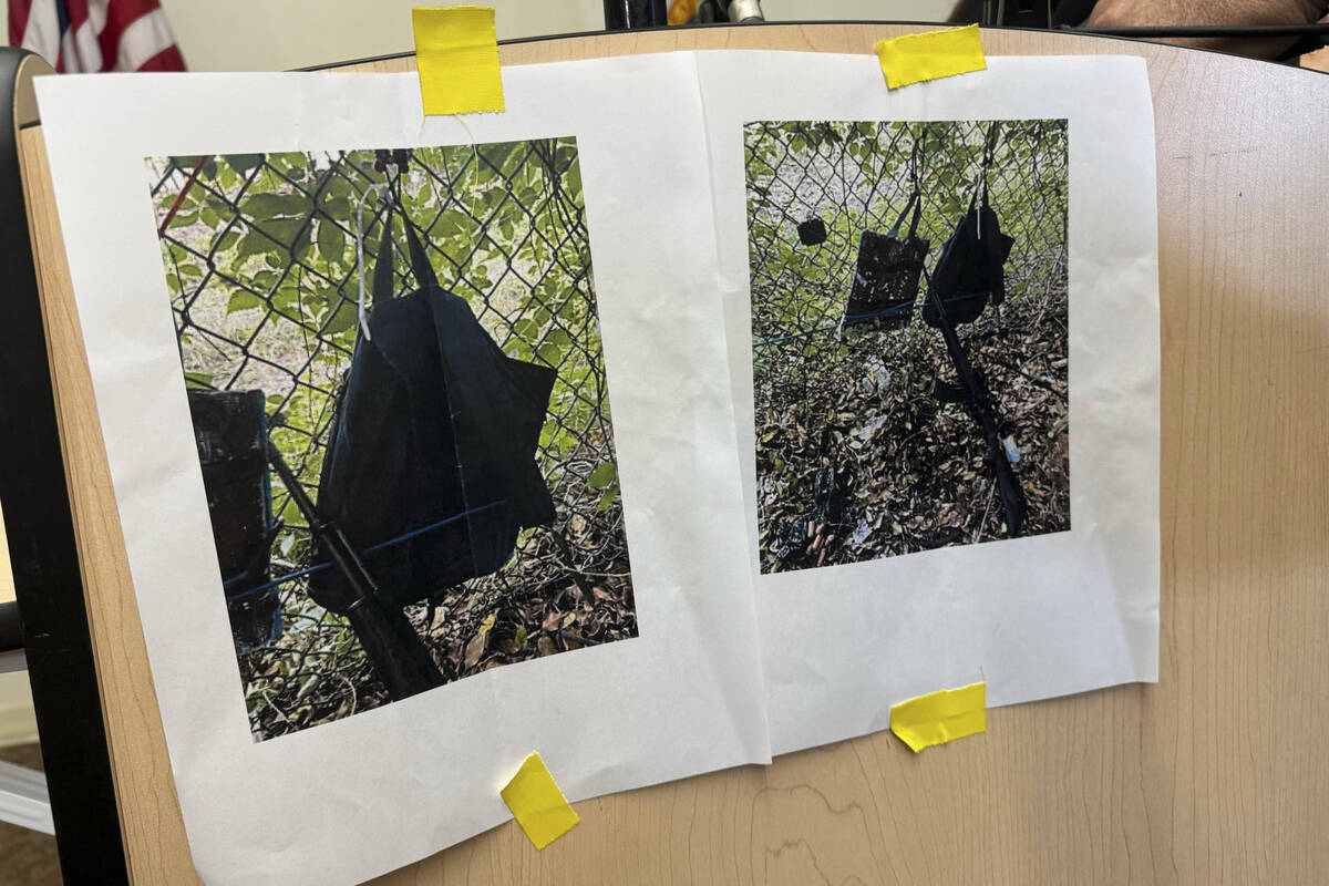 Photos that show an AK-47 rifle, a backpack and a Go-Pro camera on a fence outside Trump Intern ...