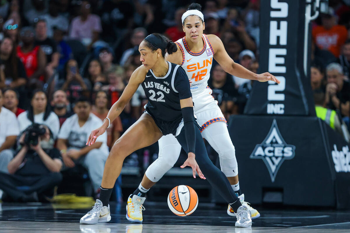 Aces center A'ja Wilson (22) works the paint as Connecticut Sun forward Brionna Jones (42) guar ...