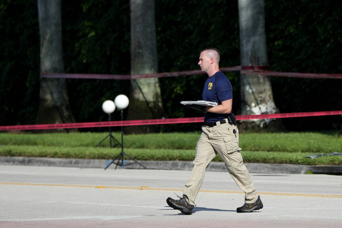 An FBI officer works outside of Trump International Golf Club after the apparent assassination ...