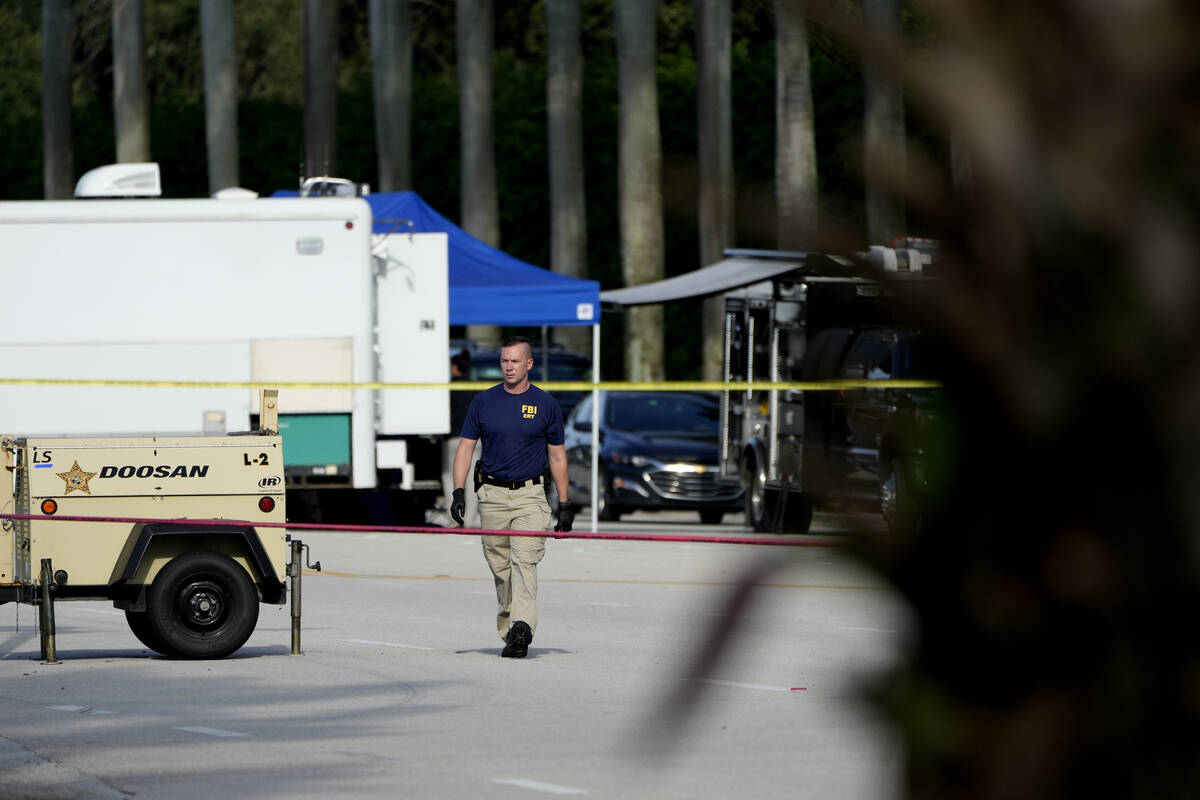 An FBI officer works outside of Trump International Golf Club after the apparent assassination ...