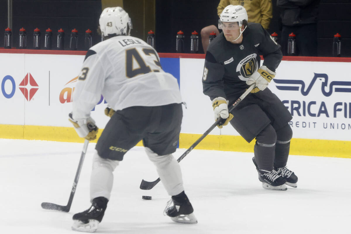 Golden Knights defenseman Mazden Leslie (43) defenses forward Mathieu Cataford (8) during first ...