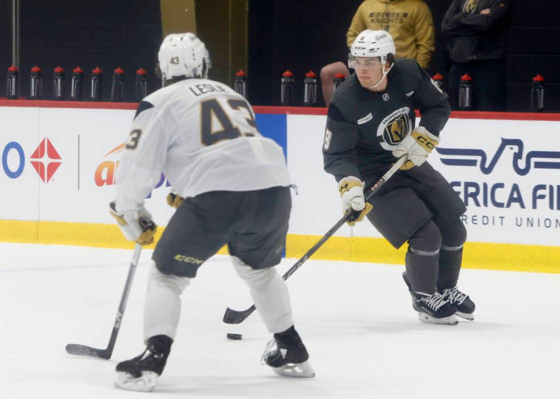 Golden Knights defenseman Mazden Leslie (43) defenses forward Mathieu Cataford (8) during first ...