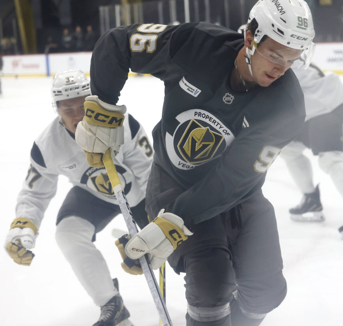 Golden Knights forward Tuomas Uronen (37) and defenseman Samuel Mayer (96) battle in the corner ...