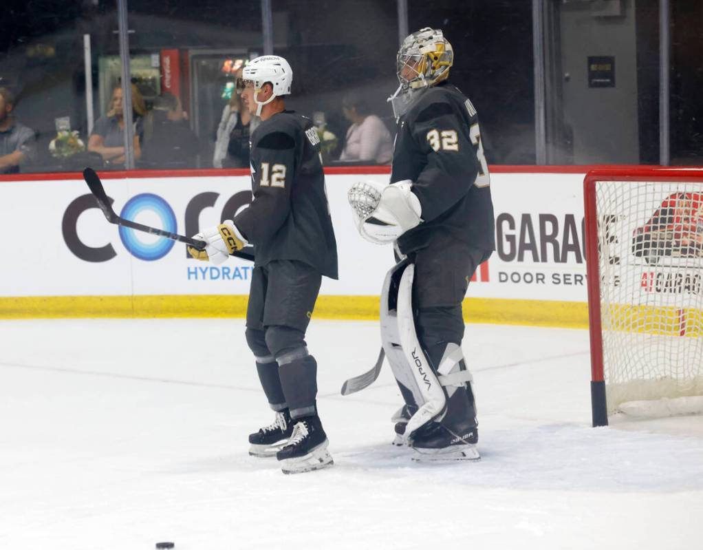 Golden Knights forward Jakub Brabenec (12) and goalie Jesper Vikman (32) wait for coach's instr ...