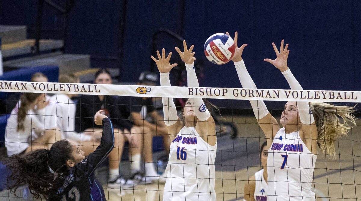 Bishop Gorman junior Charlie Wilson (16) and junior Ellie Prindl (7) attempt to block a shot by ...