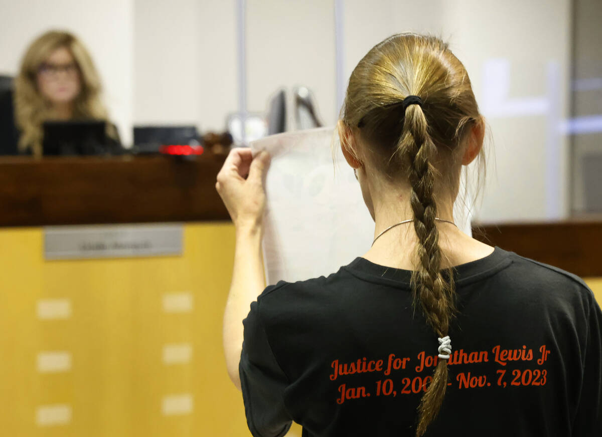 Mellisa Ready, the mother of Jonathan Lewis, wearing a "Justice for Jonathan" T-shirt, holds a ...